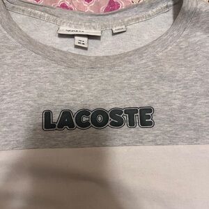 Men’s grey, white and black Lacoste tee shirt.